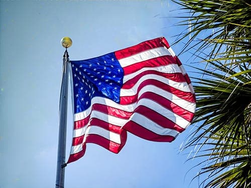 American flag flying against a clear blue sky